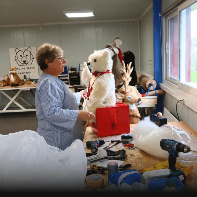 Behind the scenes of our crafting workshop, with the finest craftsmen and women and our white Leonardo bear cub sitting on gift.